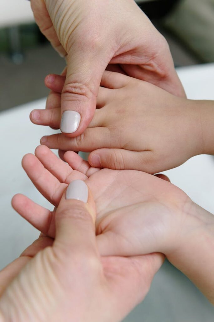 pexels-photo-6340570 Person Holding the Hands of baby